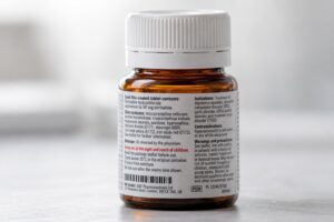 Pharmaceutical bottle whose label is filled edge to edge with small regulatory text